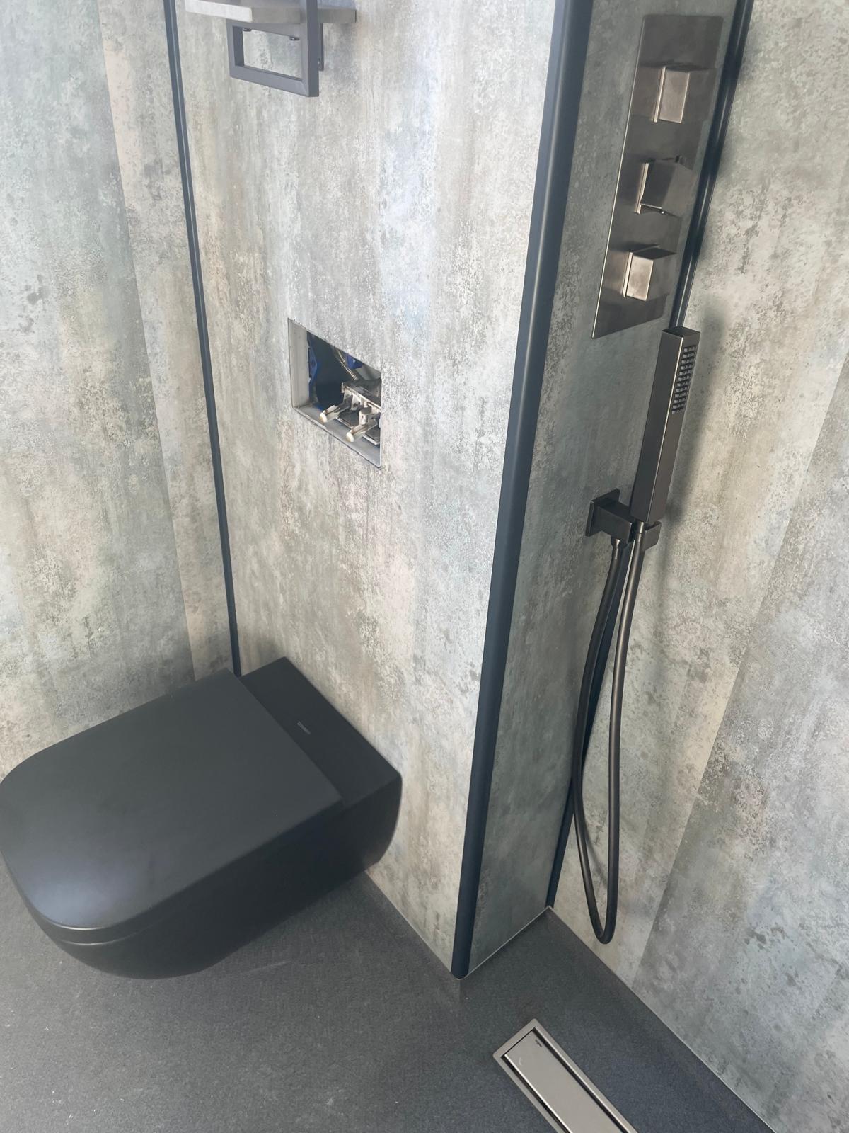 Full bathroom installation in an Edinburgh home with tiled walls and fitted joinery.