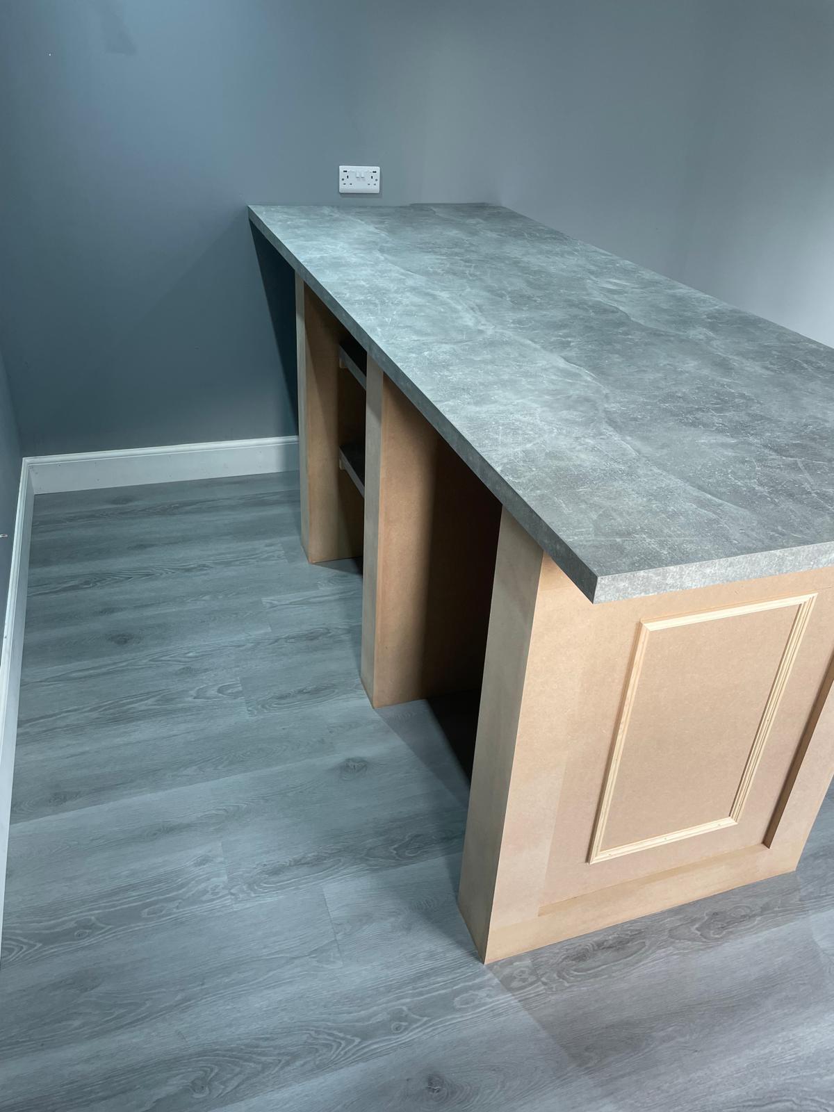 Bespoke counter unit with marble-effect top and panelled side detail.